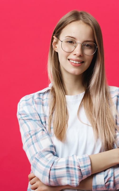 portrait-of-a-casual-woman-in-glasses-looking-at-camera-isolated-on-a-pink-background.jpg
